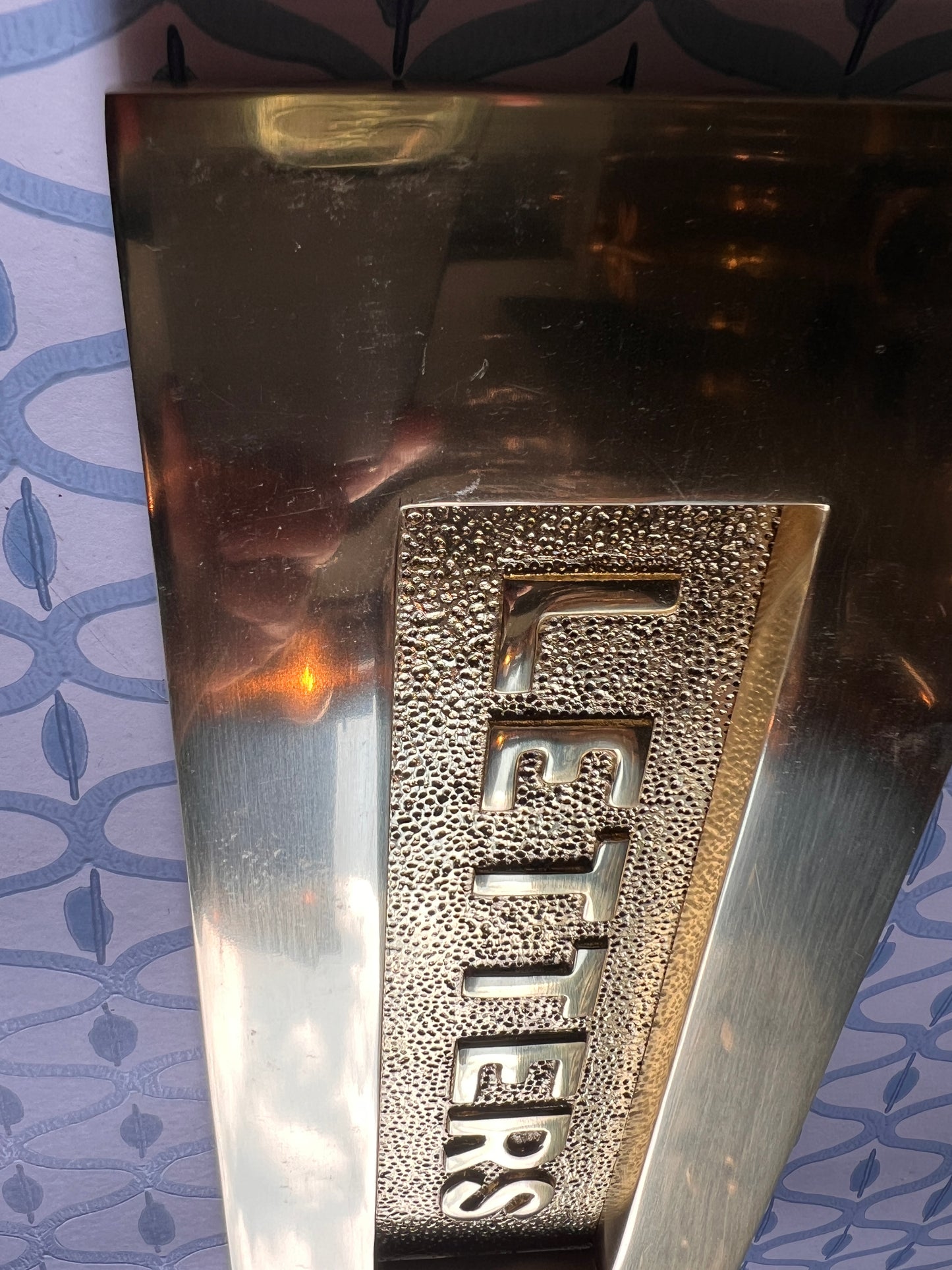 Polished brass letter plate tarnished