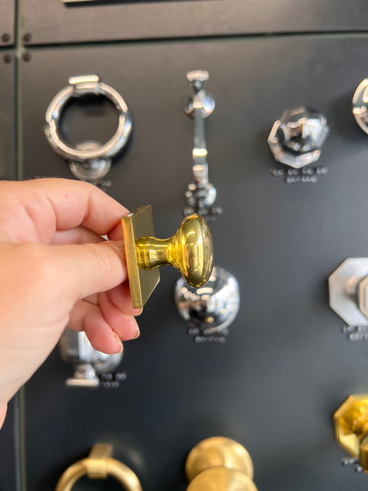 Victorian round cabinet knob with square backplate in polished brass