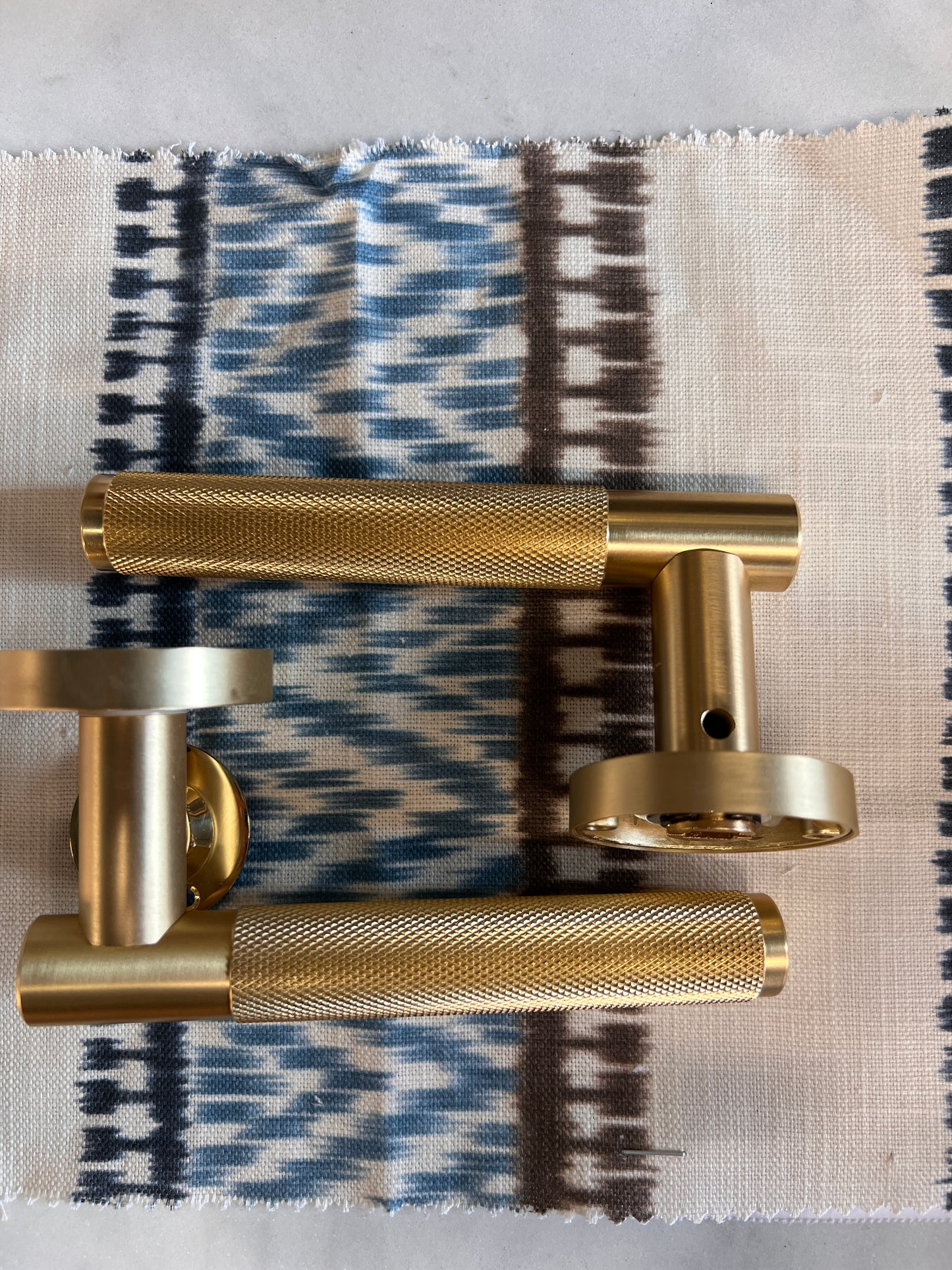 Satin brass knurled pair of lever handles