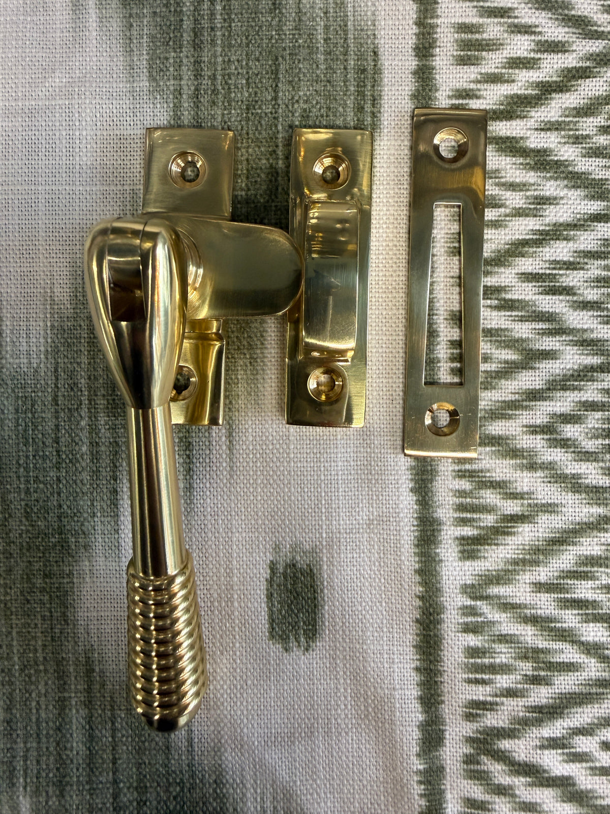 Reeded polished brass casement fastener