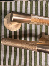 Load image into Gallery viewer, Bari knurled lever on rose door handles in satin brass
