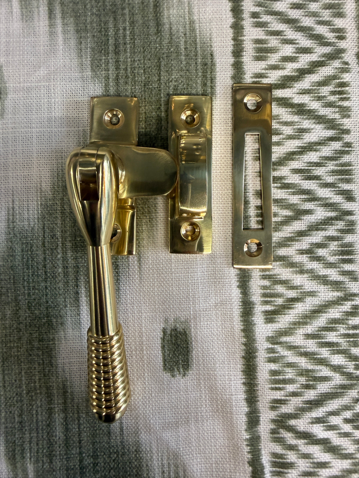 Reeded polished brass casement fastener