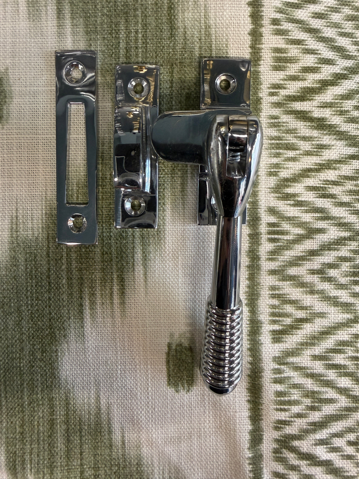 Reeded polished chrome casement fastener