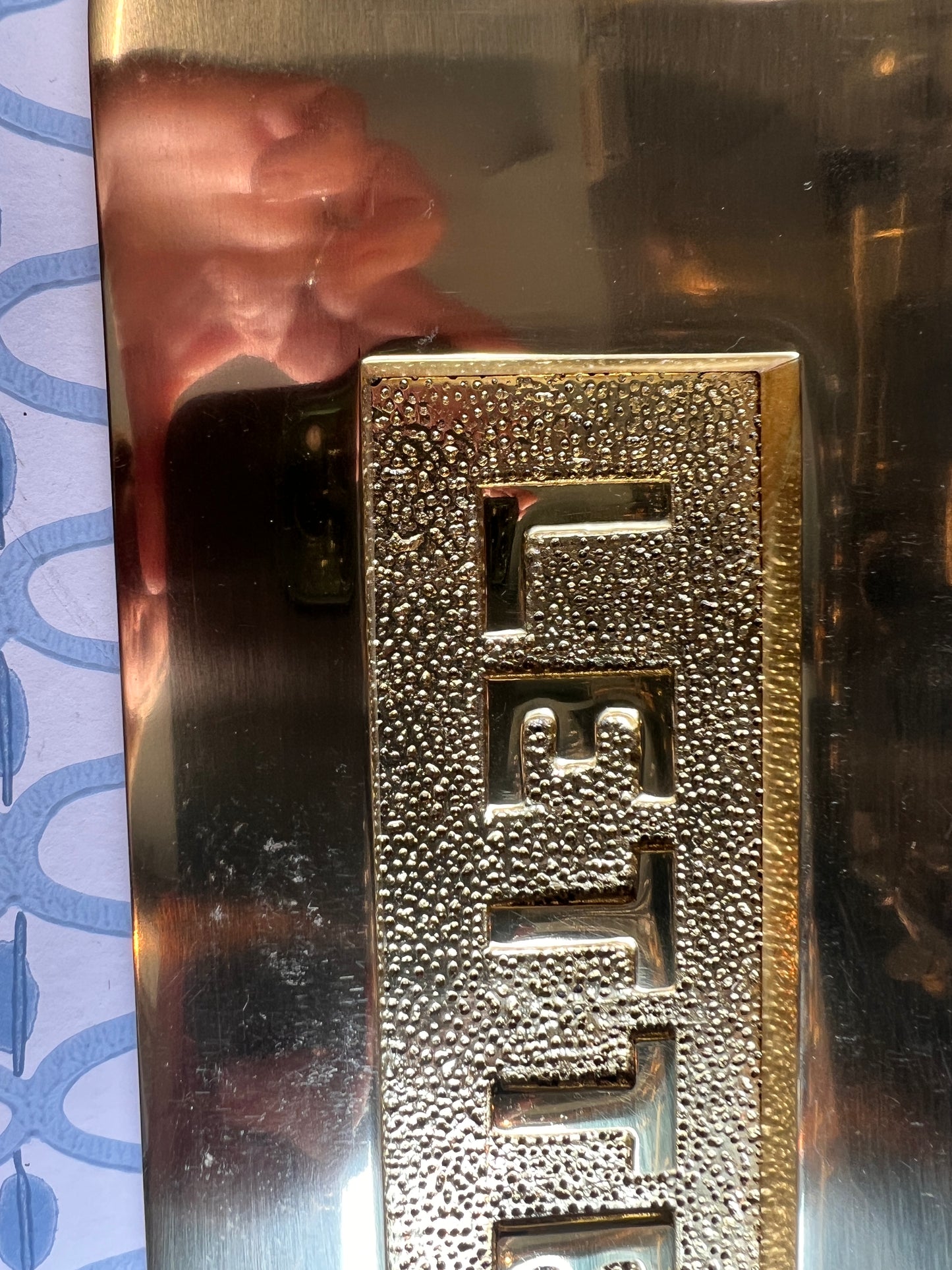 Polished brass letter plate tarnished