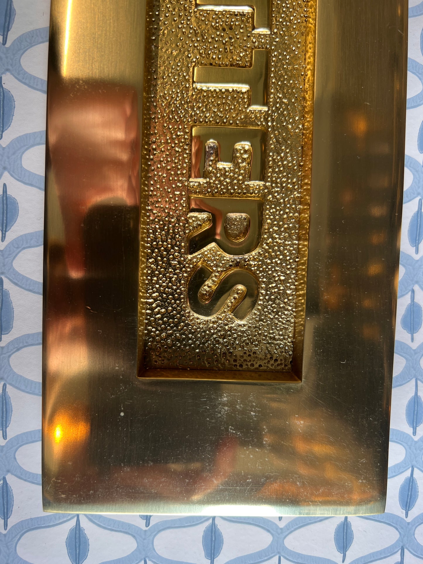 Polished brass letter plate tarnished