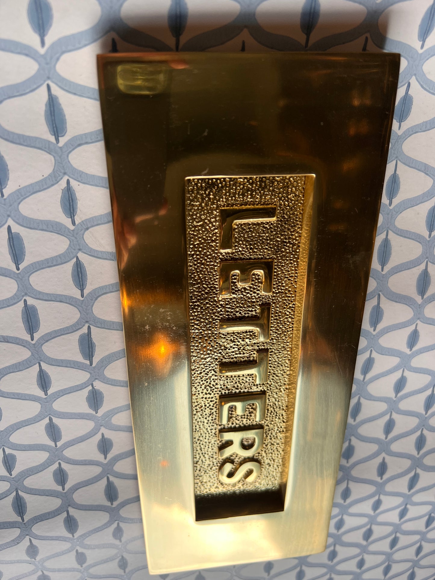 Polished brass letter plate tarnished