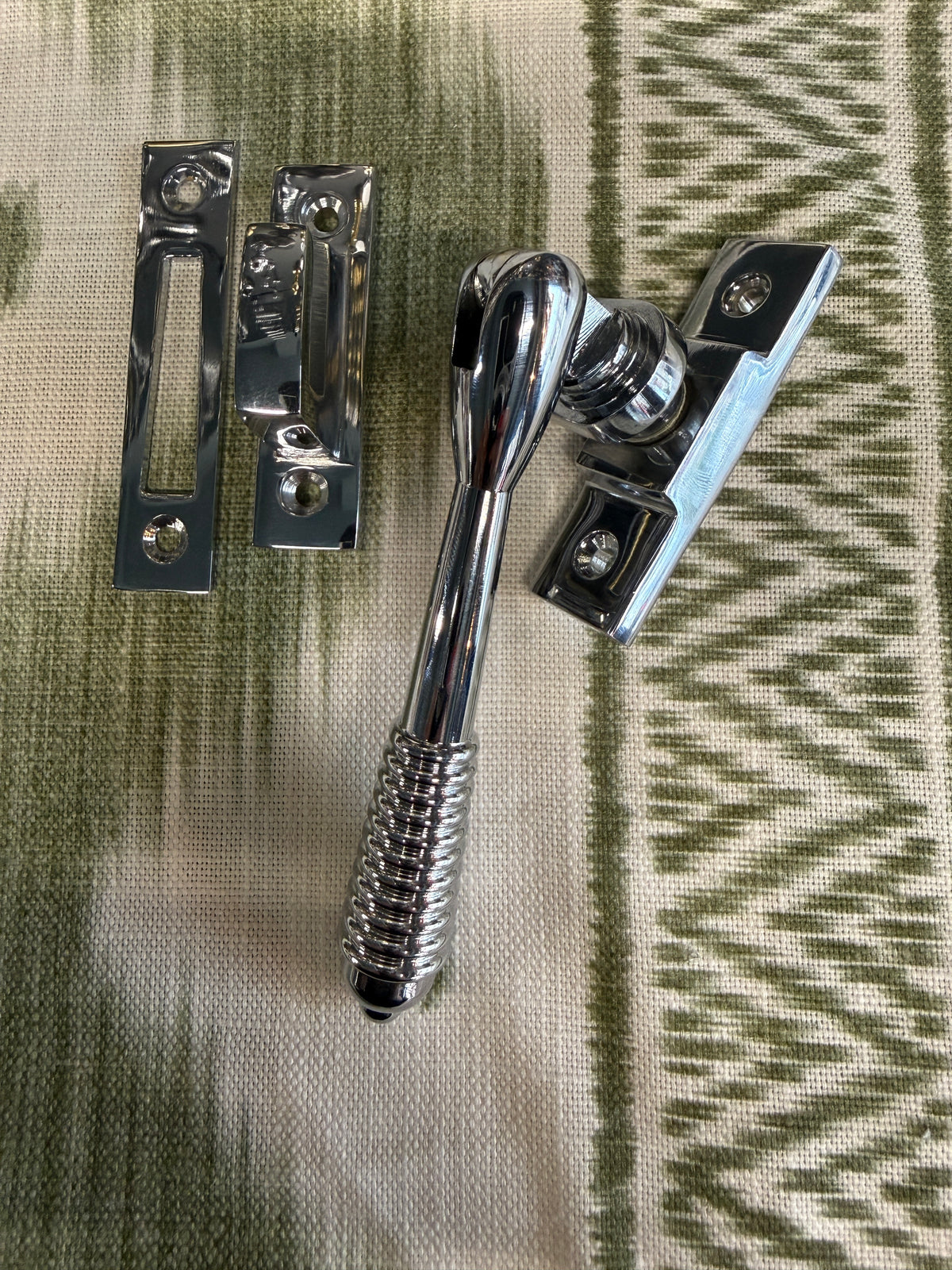 Reeded polished chrome casement fastener