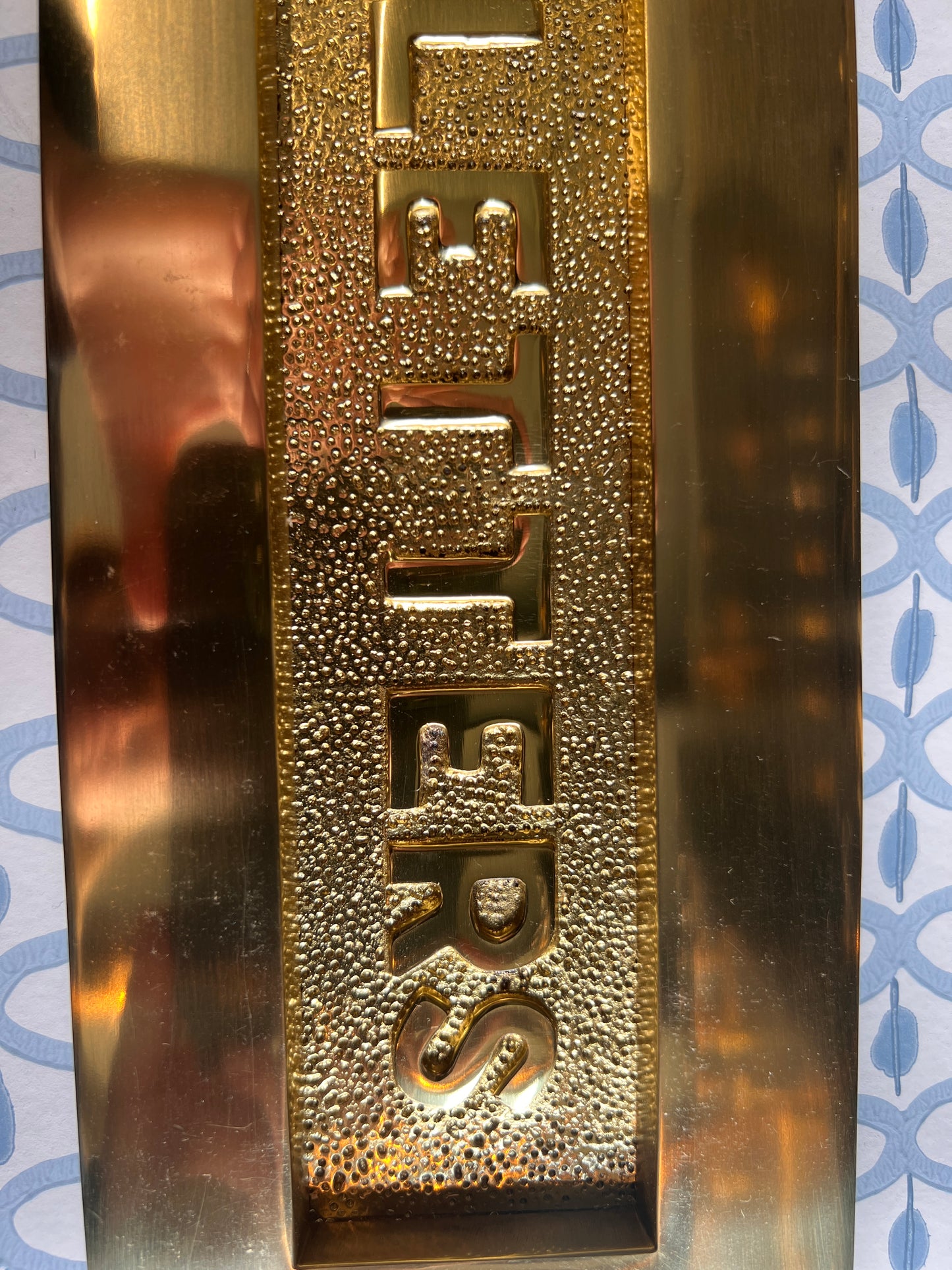 Polished brass letter plate tarnished