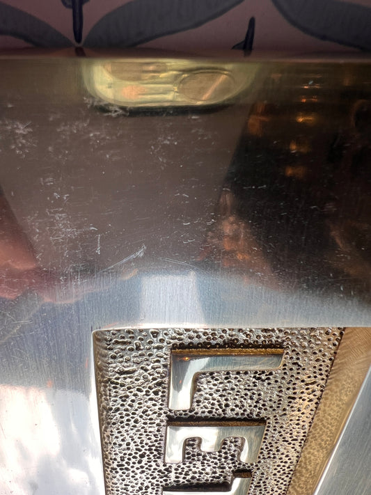 Polished brass letter plate tarnished