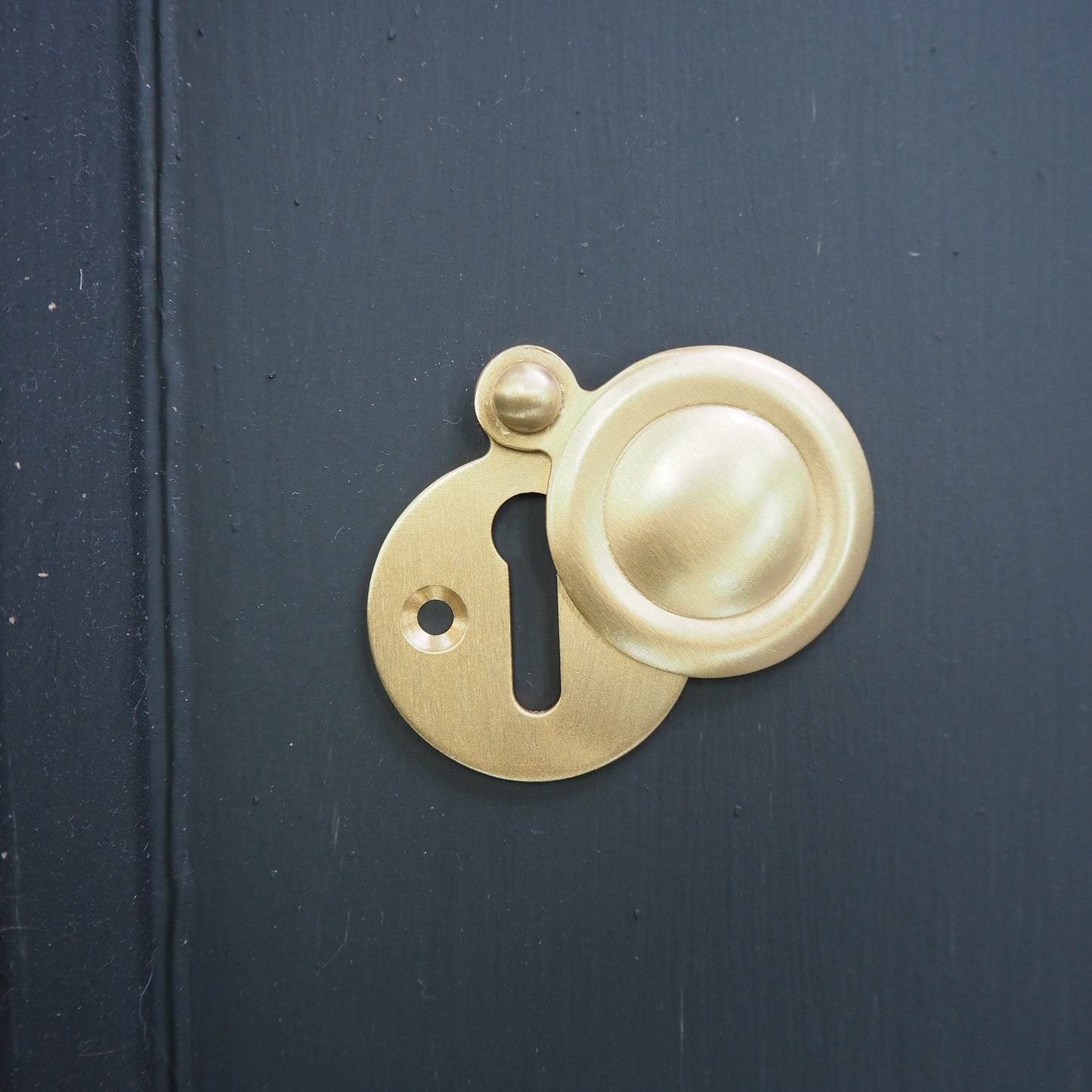 Satin brass covered round escutcheon