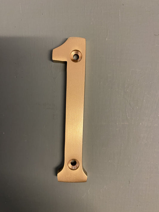 Satin brass numeral “1”