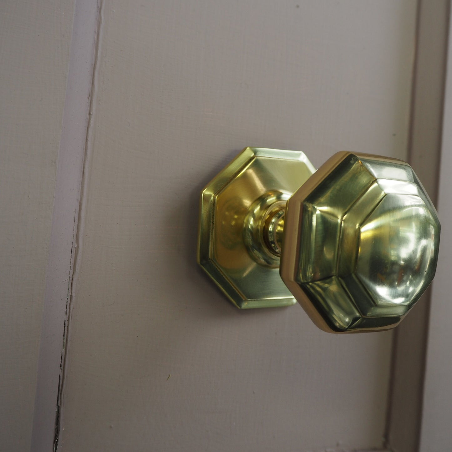 Octagonal polished brass centre door knob