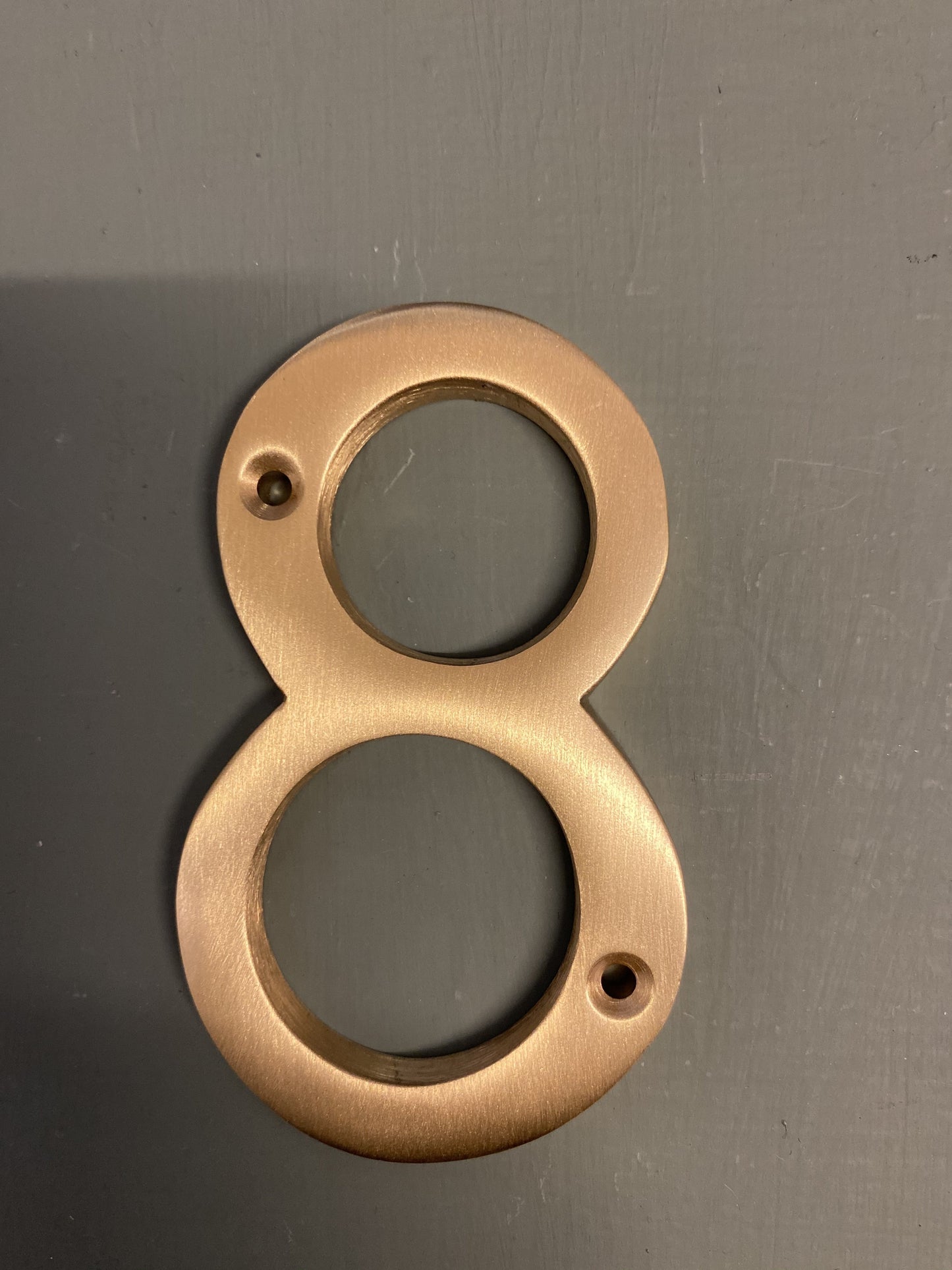 Satin brass numeral “8”