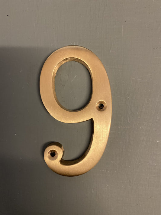 Satin brass numeral “9”