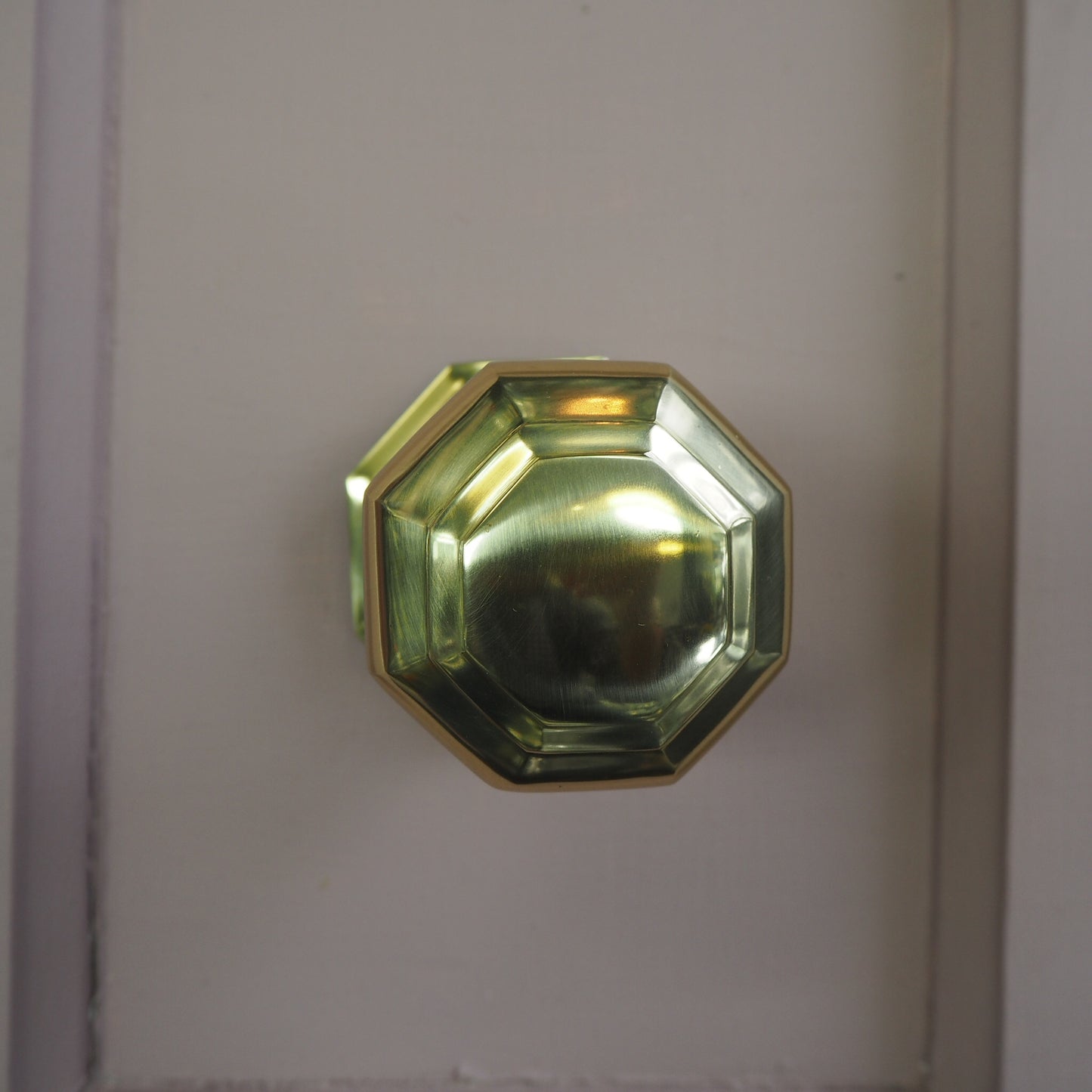 Octagonal polished brass centre door knob