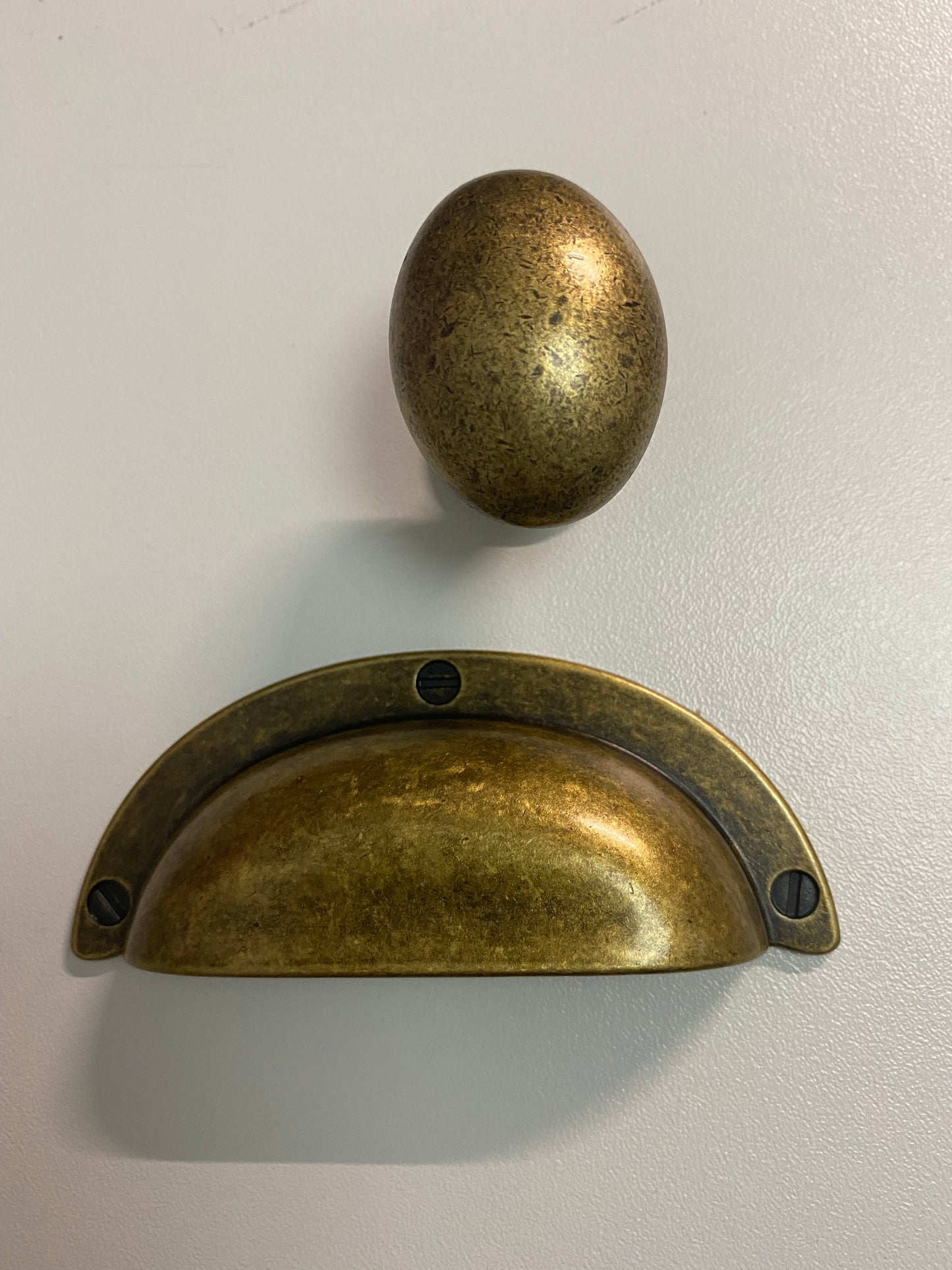 Distressed brass drawer cup pull