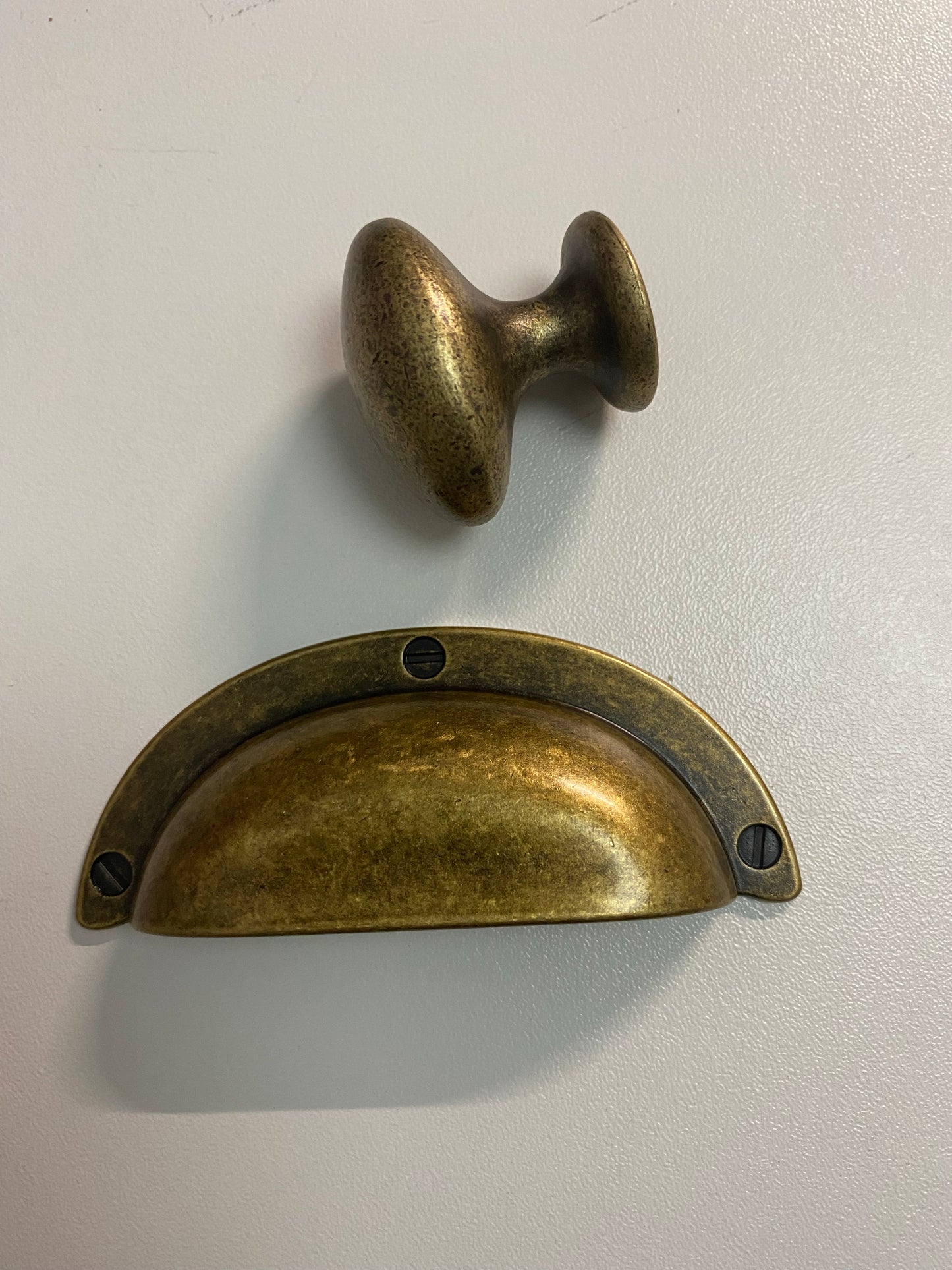 Distressed brass drawer cup pull